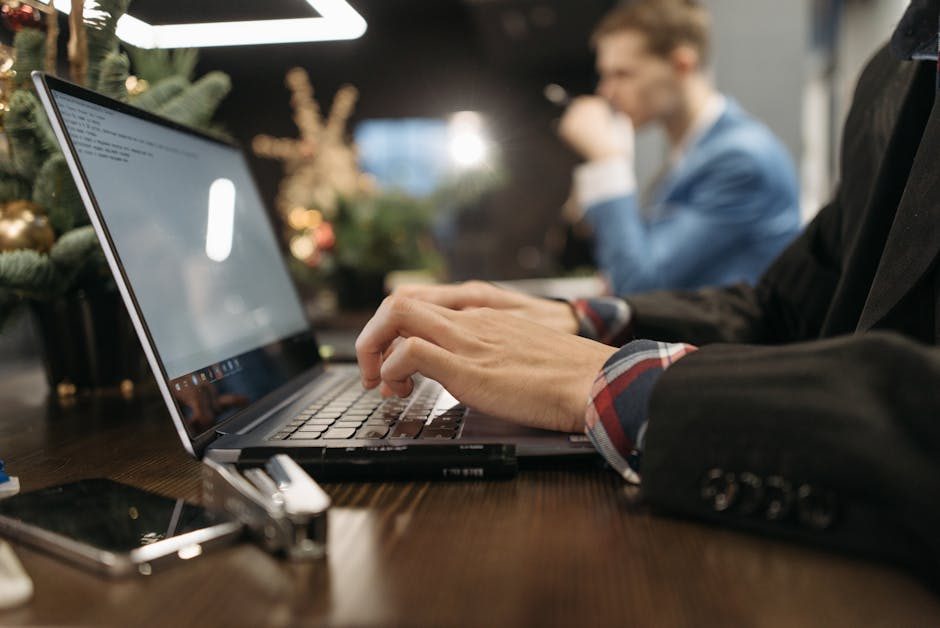 Small business team collaborating around a laptop in a modern office space.