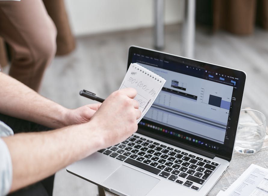 Person working at desk with multiple devices, looking productive