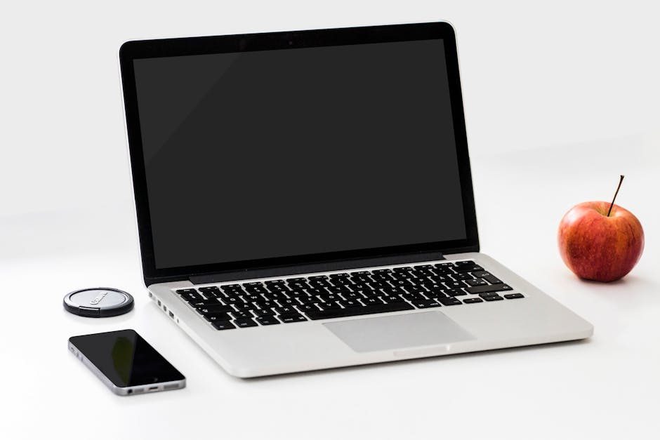 Laptop displaying multiple website builder logos on a clean desk