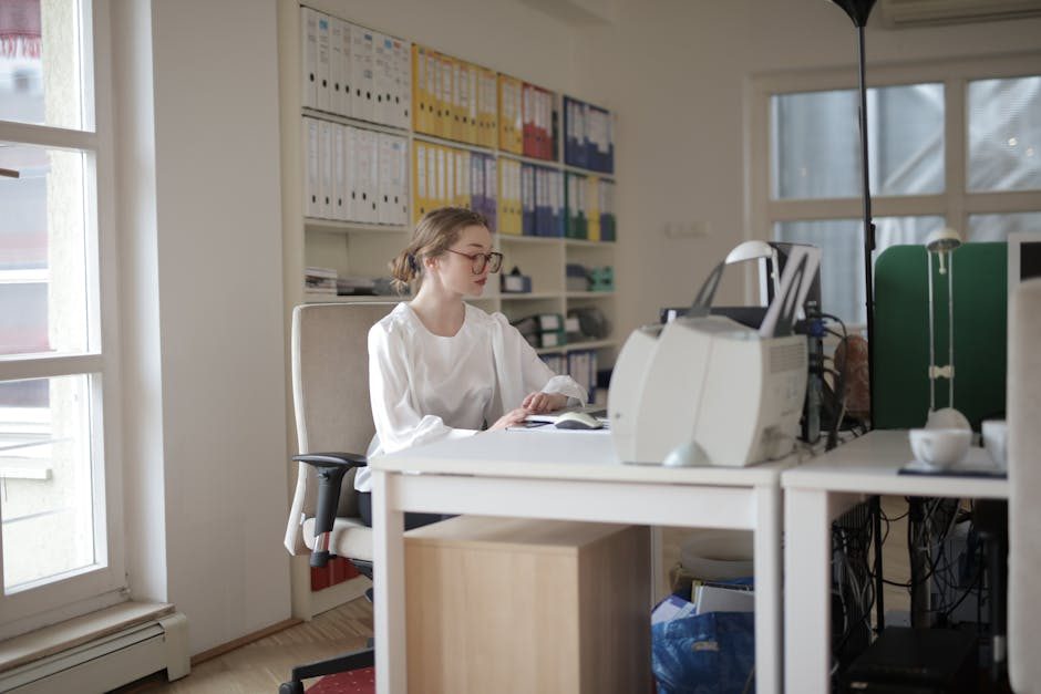 Organized workspace with a laptop showing financial software and neatly stacked receipts.