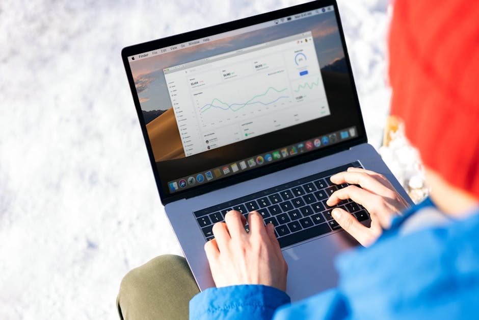 Overhead view of a laptop showing data visualizations and charts on its screen.