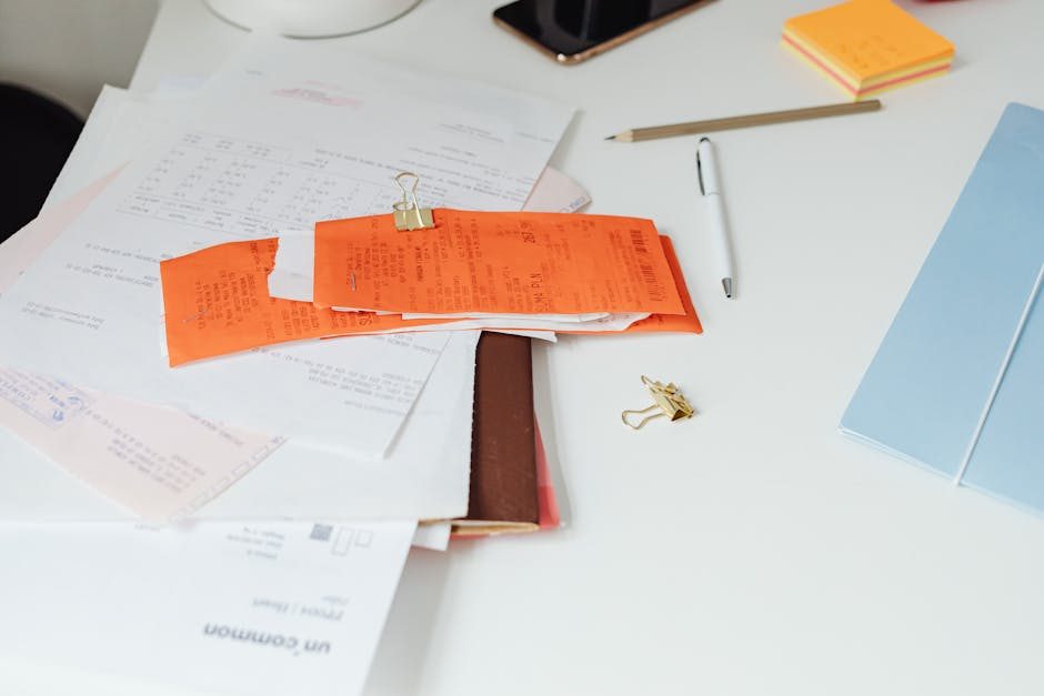 A tidy desk setting with a laptop showing a stock photo website and a smartphone.