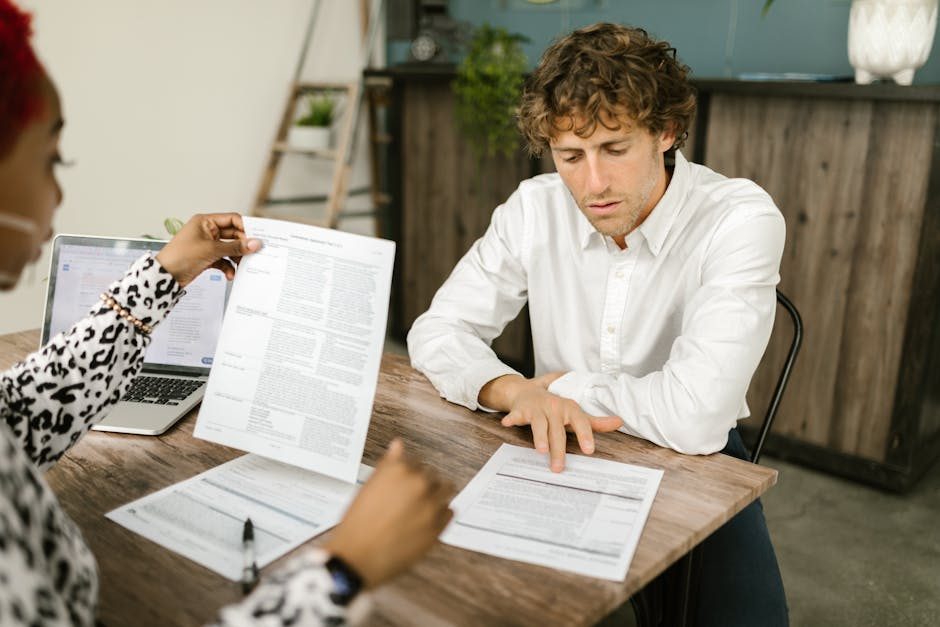 Business owner considering pricing options with calculator