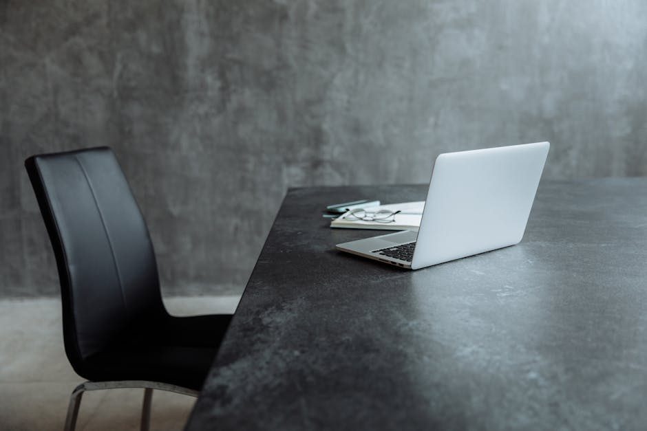 Focused woman engaged in remote work using a Trello-branded laptop in a cozy indoor setting.